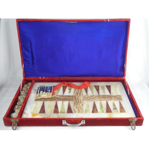 301 - A velvet cased Salima Marble Works backgammon set, board measuring 57cm x 34cm.