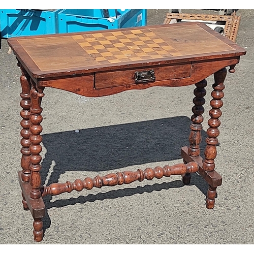 422 - An antique games table on barley twist legs and drawer, 78cm x 36cm x 68cm.