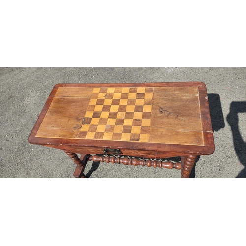 422 - An antique games table on barley twist legs and drawer, 78cm x 36cm x 68cm.