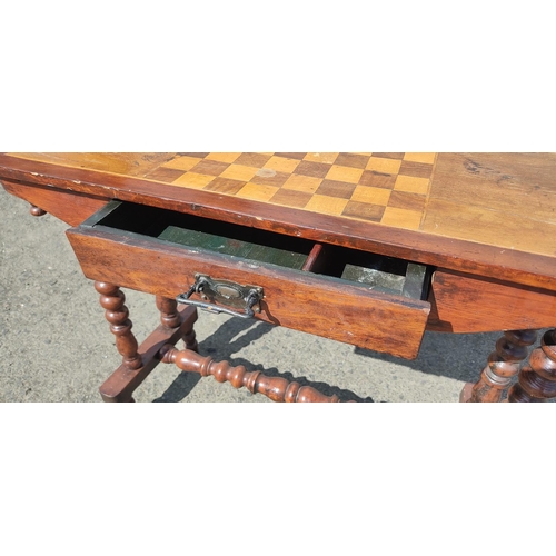 422 - An antique games table on barley twist legs and drawer, 78cm x 36cm x 68cm.