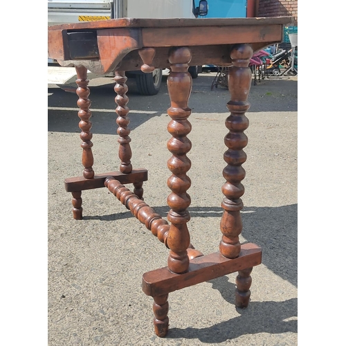 422 - An antique games table on barley twist legs and drawer, 78cm x 36cm x 68cm.