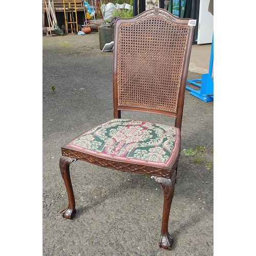 432 - An antique Berger backed chair, carved detail, ball and claw feet.