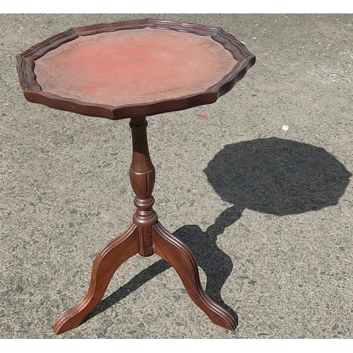 437 - A vintage leather topped wine table.