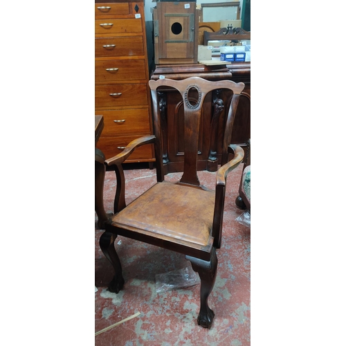 446 - An antique mahogany extending dining room table on ball and claw feet and a set of seven dining room... 