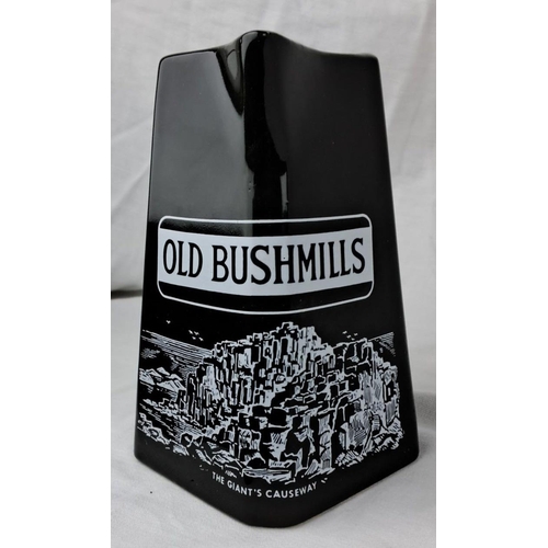 113 - Black ceramic Old Bushmills whiskey jug, featuring The Giant's Causeway. Imported Irish whiskey, 86 ... 