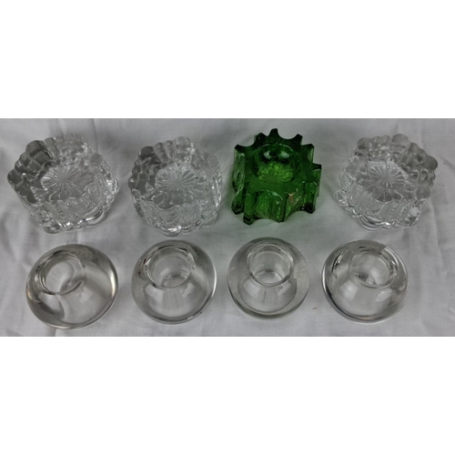 122 - Collection of 4 vintage glass candle holders. Four antique glass piano casters, including 1 uranium ... 