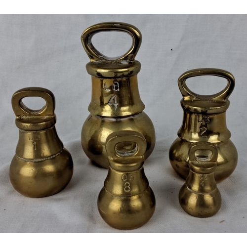 127 - Set of five vintage brass scale weights, marked in pounds and ounces. Includes 4 lb, 2 lb, 1 lb, 8 o... 