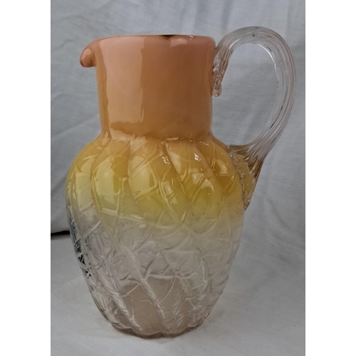 136 - Vintage glass pitcher with embossed leaf pattern and gradient orange-to-clear design. Features a cle... 