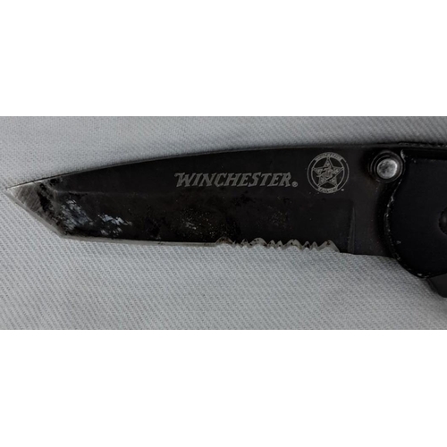 14 - Winchester folding pocket knife with serrated 440 stainless steel blade and black handle. Features s... 