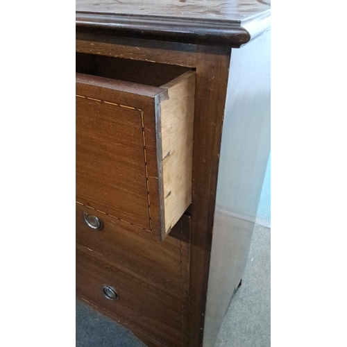 23 - Edwardian oak chest of drawers with four graduated drawers, featuring brass handles and dovetail joi... 