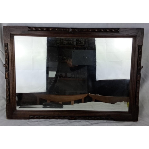 24 - Carved oak framed mirror with intricately detailed trim from the Early 20th Century. Measuring 26