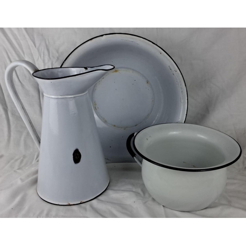 26 - Vintage enamelware set includes a white pitcher, basin, and chamber pot. Features a classic 1950s de... 