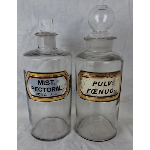 29 - Pair of vintage clear glass apothecary jars with original labels: “MIST. PECTORAL.” and “PULV: FŒNUG... 