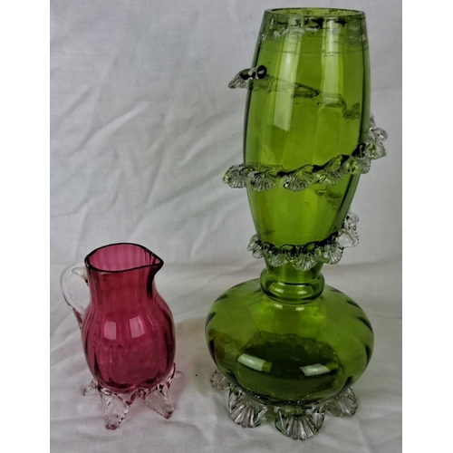 34 - Pair of hand-blown glass items: one green vase with clear ruffled accents, and one pink jug with cle... 