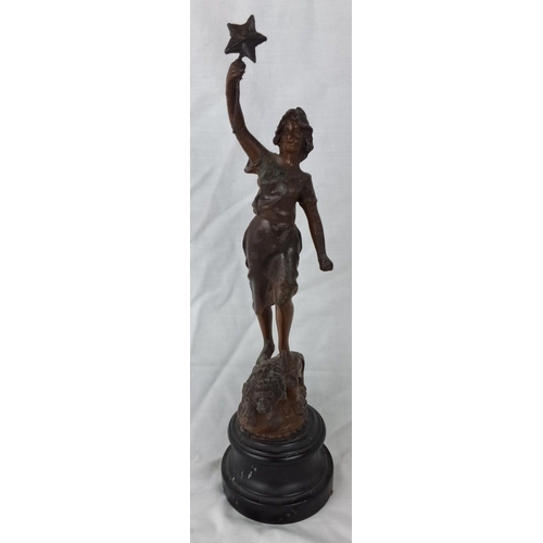 5 - Spelter statue of a female figure holding a star, standing on a black pedestal. Mid-20th century, de... 