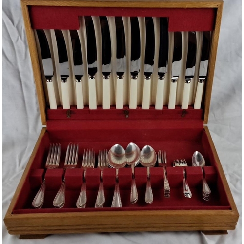 57 - Canteen of cutlery set, including forks, knives, spoons, and serving pieces, housed in a wooden box ... 