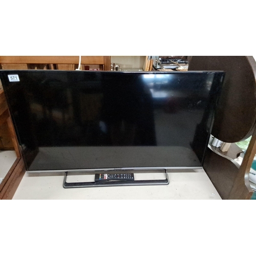 570 - Panasonic flat-screen television with remote control. Measuring 40