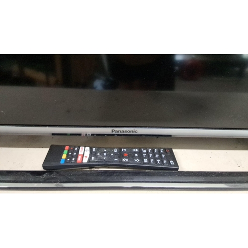 570 - Panasonic flat-screen television with remote control. Measuring 40