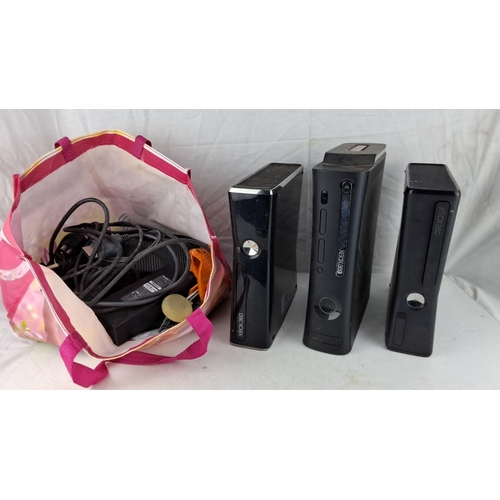 571 - Three Xbox 360 consoles and accessories.