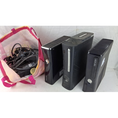 571 - Three Xbox 360 consoles and accessories.