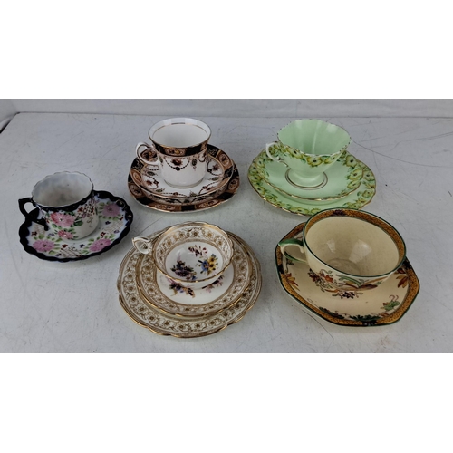 575 - Set of five vintage teacups and saucers with delicate floral patterns and gold accents. Each piece f... 