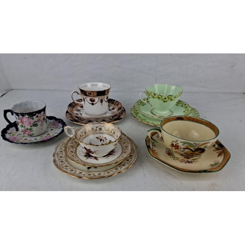 575 - Set of five vintage teacups and saucers with delicate floral patterns and gold accents. Each piece f... 