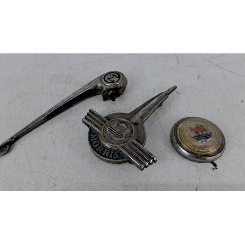 585 - Vintage Morris car badges and parts, including a chrome-plated hood ornament and a hubcap, featuring... 