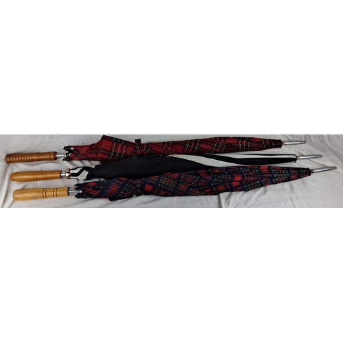 59 - Set of three plaid umbrellas with wooden handles. Two red tartan and one black with multicolor patte... 