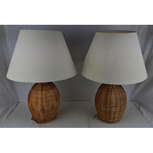 590 - Pair of wicker table lamps with white fabric shades. Height: 24 inches.