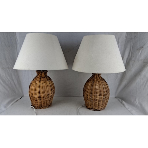 590 - Pair of wicker table lamps with white fabric shades. Height: 24 inches.