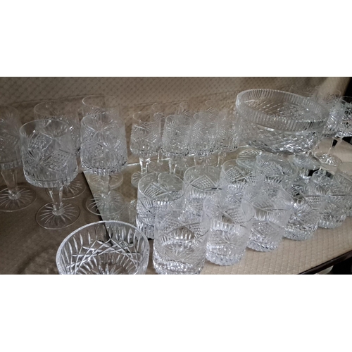 606 - Crystal glassware set, including 24 assorted glasses, 2 serving bowls, and a large punch bowl, featu... 