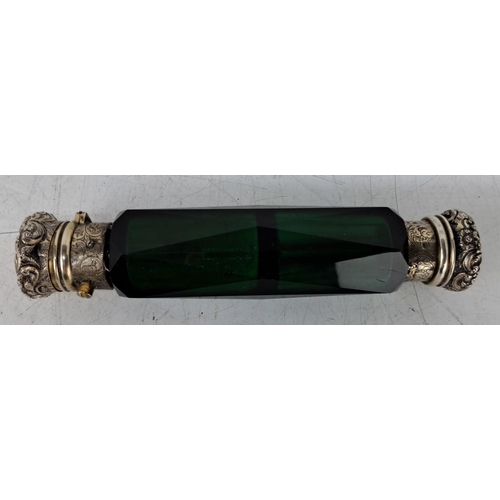 607 - Antique Victorian green glass perfume bottle. Ornate engraved Sterling Silver caps. Faceted glass su... 