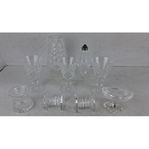 611 - Collection of nine cut glass crystal items. Includes goblets, a vase, a salt shaker with a silver to... 