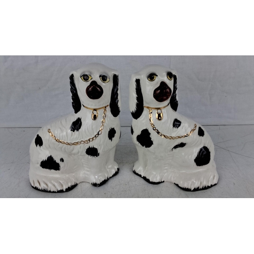 612 - Pair of Staffordshire porcelain spaniel figurines with gold chain accents and black spots.