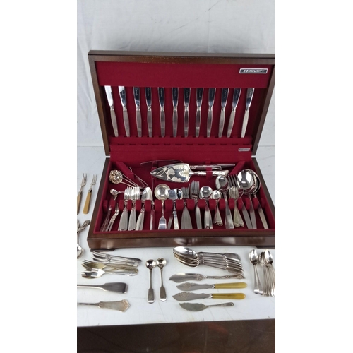 619 - Silver-plated flatware set in wooden case, including knives, forks, spoons, and serving utensils.