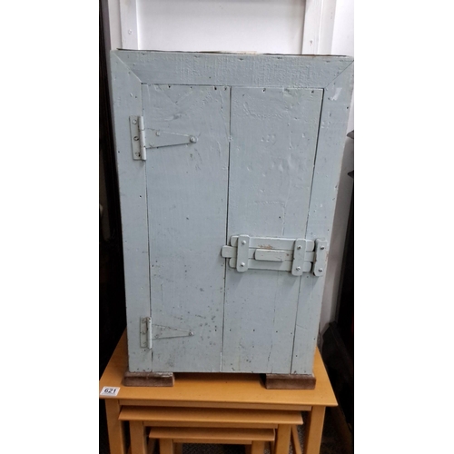 620 - A vernacular wooden storage cabinet with a pale blue distressed finish, featuring a hinged door and ... 