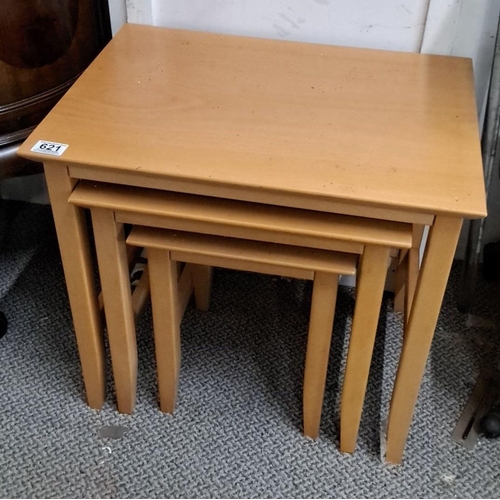 621 - Set of three nested tables in light wood finish.