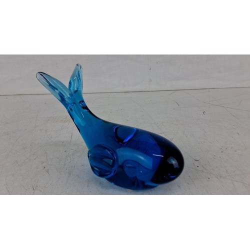 624 - Blue glass whale figurine with smooth curves and simplistic detailing features deep blue hues and ha... 