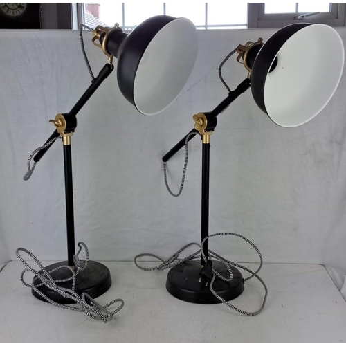 627 - Pair of desk lamps in an adjustable design. The lamps feature a black and brass color scheme, with w... 