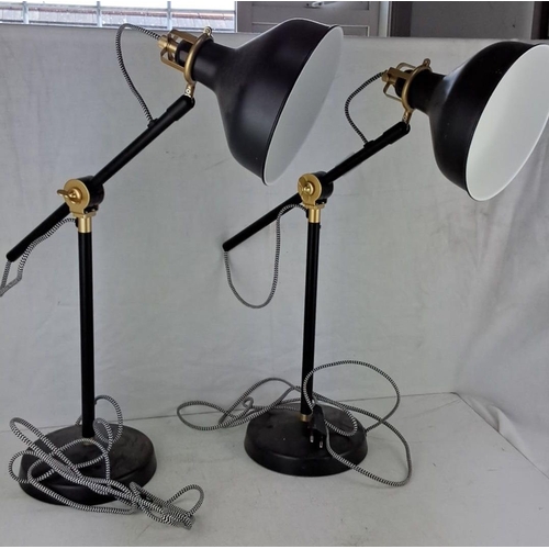 627 - Pair of desk lamps in an adjustable design. The lamps feature a black and brass color scheme, with w... 