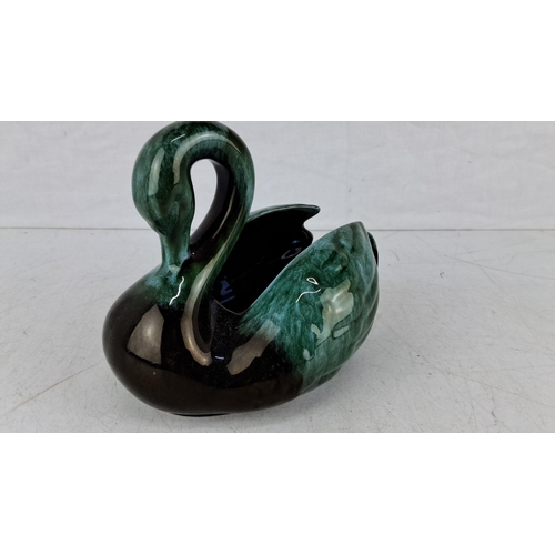 629 - Handcrafted ceramic swan figurine, glazed in shades of emerald green and black, with a smooth finish... 