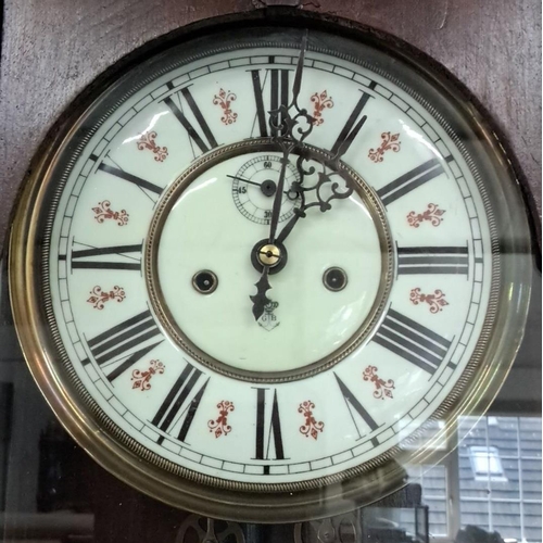 67 - An antique Gustav Becker wall clock featuring a glass front and intricate wood turned spindles. The ... 