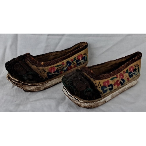 8 - Pair of vintage Chinese embroidered platform shoes. The shoes feature floral motifs on a beige fabri... 