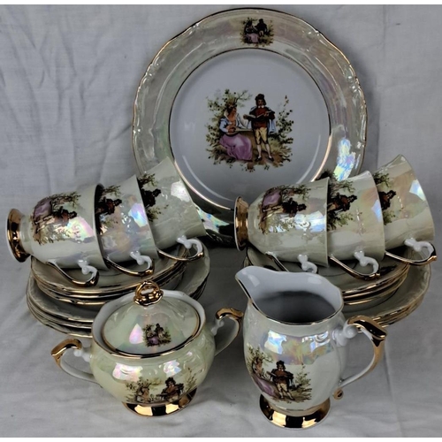 83 - Chodziez porcelain tea set made in Poland. Includes cups, saucers, plates, sugar bowl, and creamer, ... 