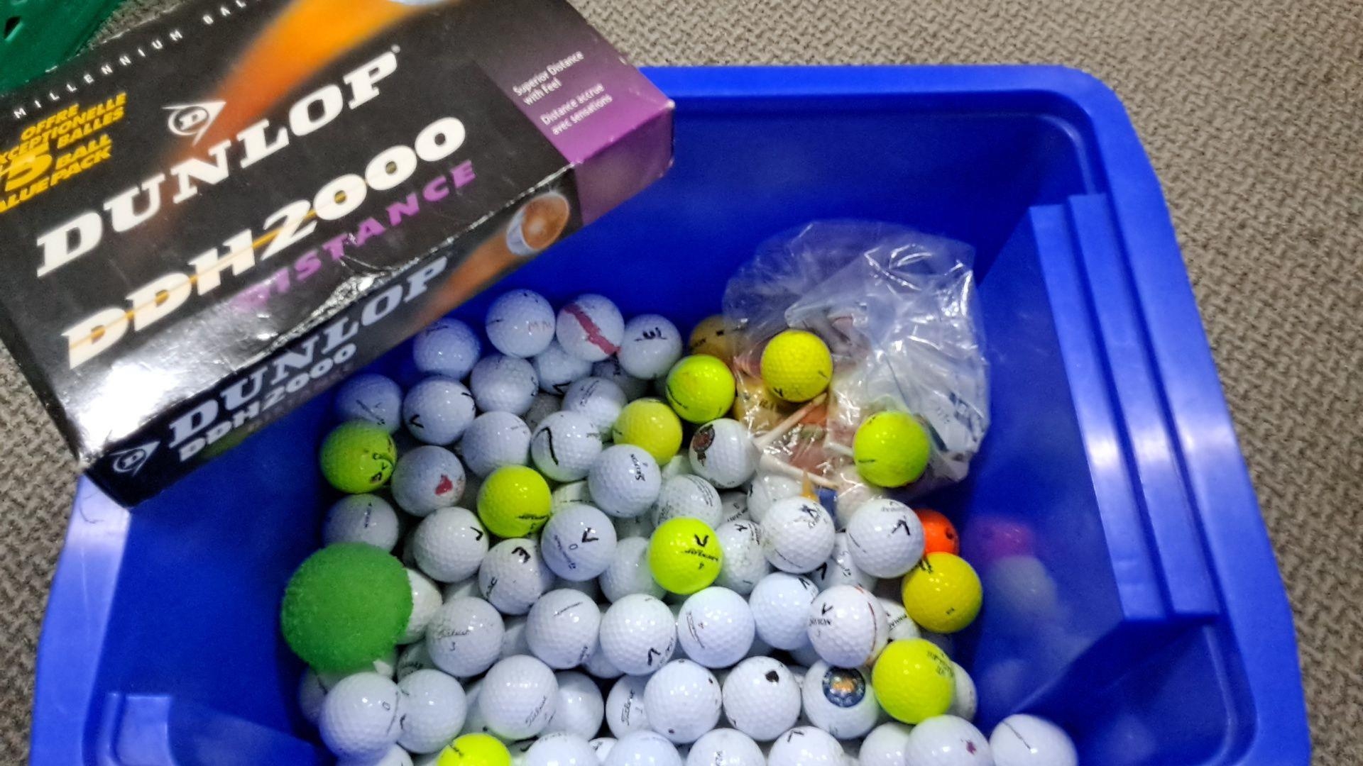 Collection of mixed golf balls, featuring various brands and colors ...