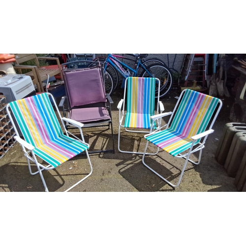 643 - Set of four colorful lawn chairs with striped fabric and white metal frames.