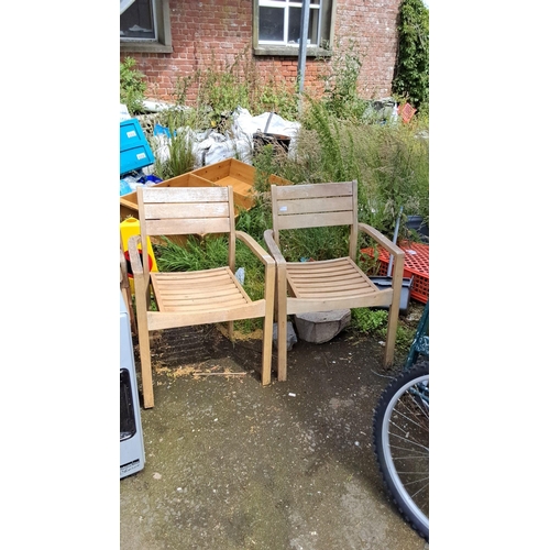 651 - Pair of wooden outdoor chairs with slatted backs and seats.