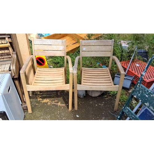 651 - Pair of wooden outdoor chairs with slatted backs and seats.