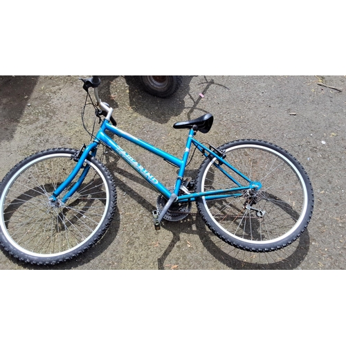 655 - Tamarind Concept mountain bike, blue frame, with knobby tires, standard brakes, and a comfortable sa... 