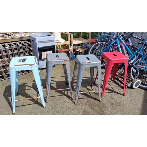 660 - Set of four vintage industrial metal stools in mixed colors.